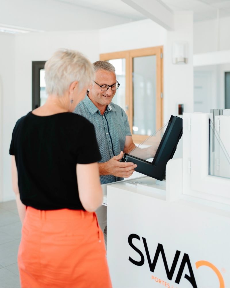 un commercial SWAO qui présente les produits à une cliente dans un showroom swao